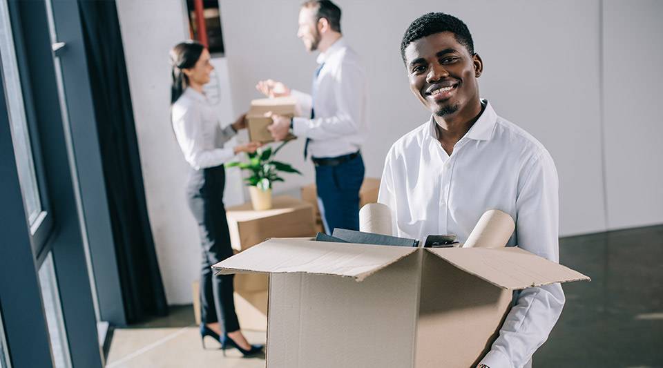 Smiling man with a box delivered and unpacked